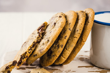 Chocolate chip cookies on old white wooden cutting board. American cuisine. Copy space.