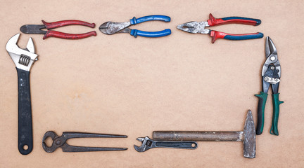Old dirty tools on wooden background. Construction industry concept