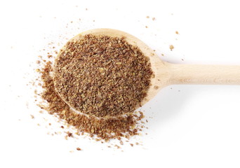 Ground, milled flaxseed, linseed with wooden spoon isolated on white background