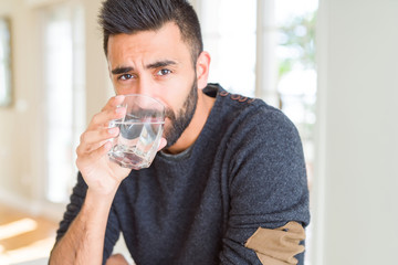 Handsome man drinking a fresh glass of water