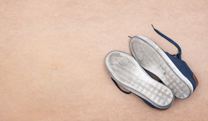 White dirty sole of sport shoes on soft background. Concept of activivity