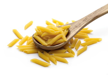 Penne rigate pasta pile with wooden spoon isolated on white background