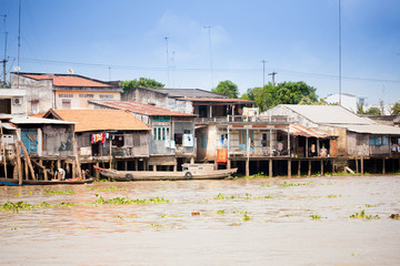 JAN 28 2014 - MY THO, VIETNAM - Houses by a river, on JAN  28, 2014, in  Mekong Delta, Vietnam