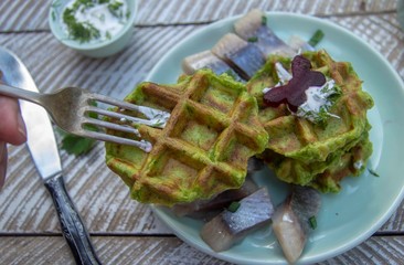 snacks potato-spinach waffles with beet and herring garnish