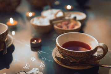 a cup of red tea and sugar cubes with different tastes, handmade, on the glass table, eastern tea ceremony. dark. Selective focus, copy space, Hookah concept, making clouds, Arabian interior.