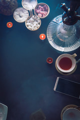 Hookah on glass table top view. cups candle and smartphone eastern tea ceremony. Selective focus, sugar cubes with different flavors. Copy space, vertical photo