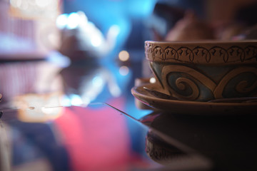 Hookah, Arabian interior. a cup of tea and sugar cubes with different tastes, handmade, a smartphone on the table, eastern tea ceremony. dark theme, Selective focus, copy space