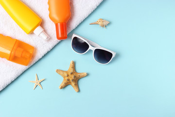  seashells, beach accessories and sun protection on a colored background top view. Sunscreen