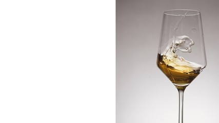 glass of white wine with wave on white background