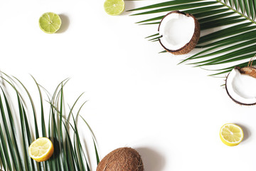 Decorative styled floral frame, web banner. Coconuts, lemons and lime fruit on lush palm leaves...
