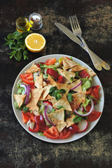 Bright healthy salad with vegetables and pita bread. Middle Eastern cuisine. Arab salad Fattush.