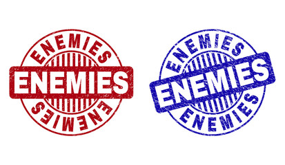 Grunge ENEMIES round stamp seals isolated on a white background. Round seals with grunge texture in red and blue colors. Vector rubber imitation of ENEMIES tag inside circle form with stripes.