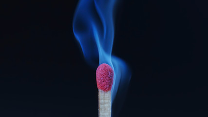 Macro shot of a wooden safety matchstick emitting blue smoke before lighting up..