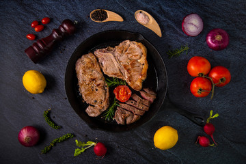 Grilled ribeye beef steak, herbs and spices. Top view