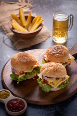 A delicious grilled Angus burger with cheese, lettuce, and tomato on a sesame seed bun