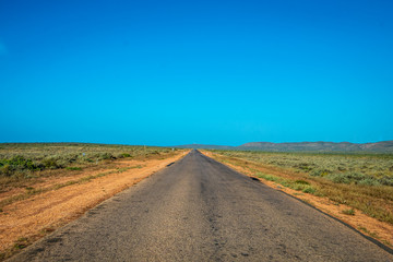 Fototapeta na wymiar Empty Australian Road inside the Cape Range National Park close to Exmouth