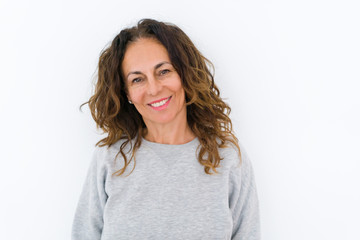 Beautiful middle age woman with curly hair smiling cheerful and happy, laughing with a big smile on face showing teeth over white isolated background