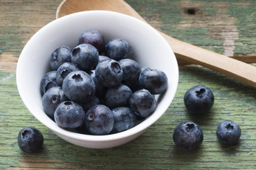 appetizing blueberries on white bowl, healthy summer fruits or ingredients for desserts