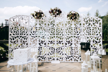 Wedding arch decorated with red flowers