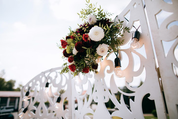 Wedding arch decorated with red flowers