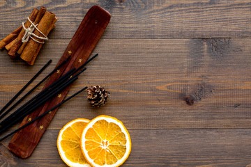 citrus and cinnamon fragrance diffuser for air freshness on wooden background top view mock-up