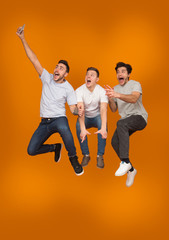 Fooling together. Men taking selfie when jumping