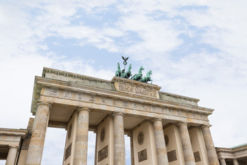 Famous neoclassical Brandenburg Gate (Brandenburger Tor) in Berlin, Germany, on a cloudy day. Copy space.