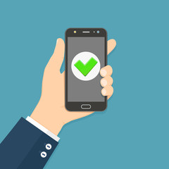 Flat design style human hand holding smartphone with green check mark on the screen