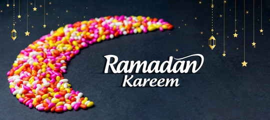 Colorful Ramadan kareem concept background with sweet candy chocolate isolated with black...