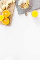 Bright breakfast with granola and orange juice on white background top view mockup