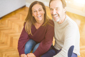 Beautiful romantic couple sitting together on the floor at home