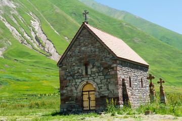 Fototapeta na wymiar Kazbegi, Georgia - Jul 01 2018: Abano monastery at Truso valley near Caucasus mountain. a famous Historic site in Kazbegi, Mtskheta-Mtianeti, Georgia.