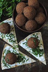 Fresh falafel with white sauce, greens and pita. Middle Eastern cuisine. Healthy food.