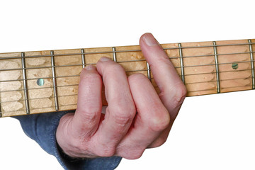 Guitarist’s hand fretting  a barre A Major chord on a maple fretboard of an electric guitar...