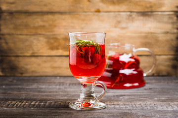 Hot raspberry beverage with rosemary. Selective focus. Shallow depth of field.