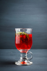 Hot raspberry beverage with rosemary. Selective focus. Shallow depth of field.