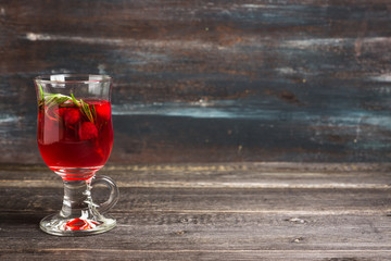 Hot raspberry beverage with rosemary. Selective focus. Shallow depth of field.