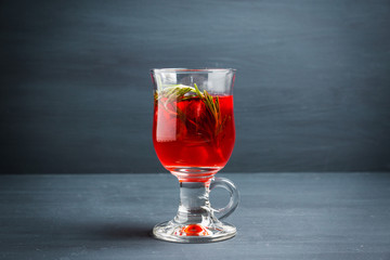 Hot raspberry beverage with rosemary. Selective focus. Shallow depth of field.