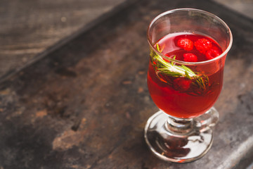 Hot raspberry beverage with rosemary. Selective focus. Shallow depth of field.