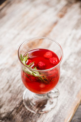 Hot raspberry beverage with rosemary. Selective focus. Shallow depth of field.
