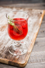 Hot raspberry beverage with rosemary. Selective focus. Shallow depth of field.