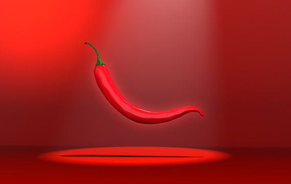 Chili Pepper Floating On A Red Back Ground.