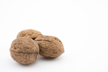 Walnuts on white background. The health benefits of walnuts are many.