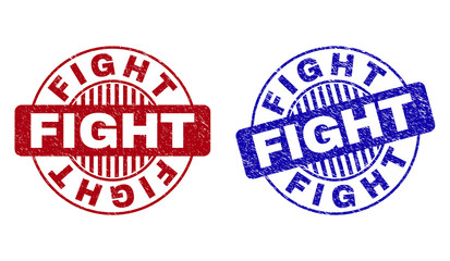 Grunge FIGHT round stamp seals isolated on a white background. Round seals with grunge texture in red and blue colors. Vector rubber imitation of FIGHT caption inside circle form with stripes.