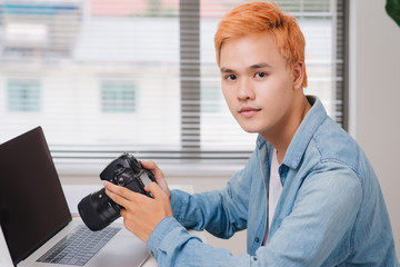 Photographer working at desk in modern office