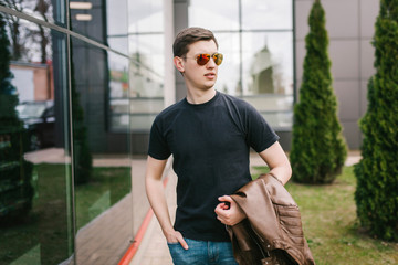 A stylish man in a black T-shirt. Street photo