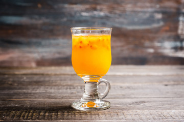 Hot buckthorn beverage in glass. Selective focus. Shallow depth of field. 