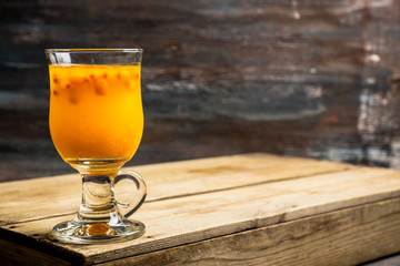 Hot buckthorn beverage in glass. Selective focus. Shallow depth of field. 