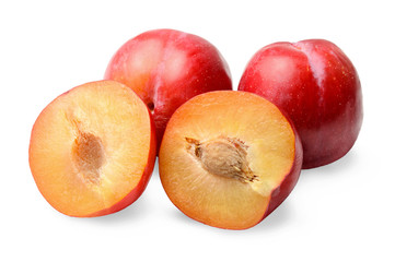 Red round plums. Whole and halves. White isolated background. Side view.
