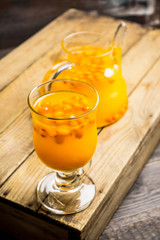Hot buckthorn beverage in glass. Selective focus. Shallow depth of field. 